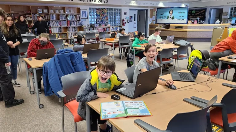 children having fun learning to code using scratch book