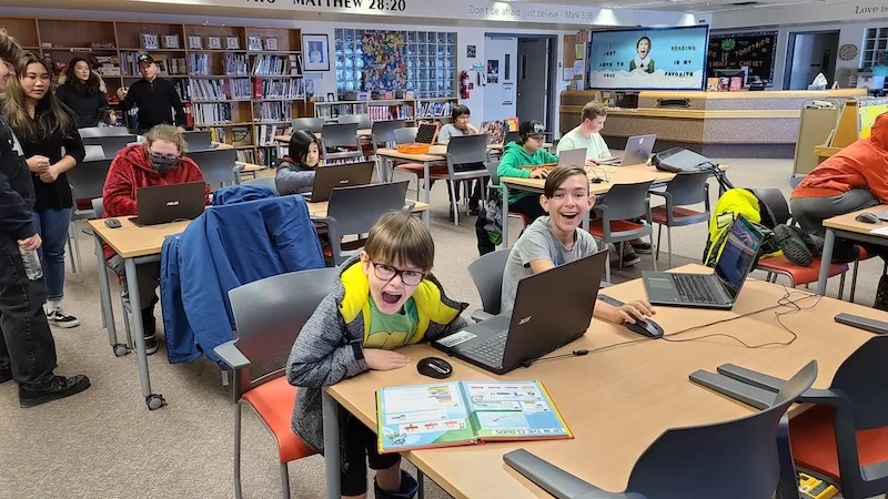 children having fun learning to code using scratch book